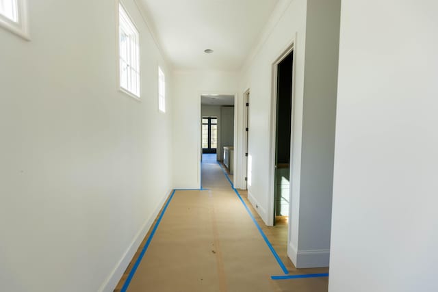 hallway featuring ornamental molding