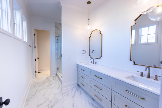 full bath with marble finish floor, crown molding, a marble finish shower, a sink, and baseboards