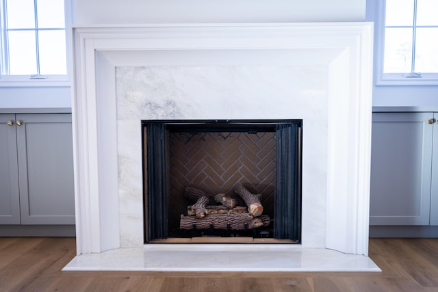 interior details featuring a fireplace and wood finished floors