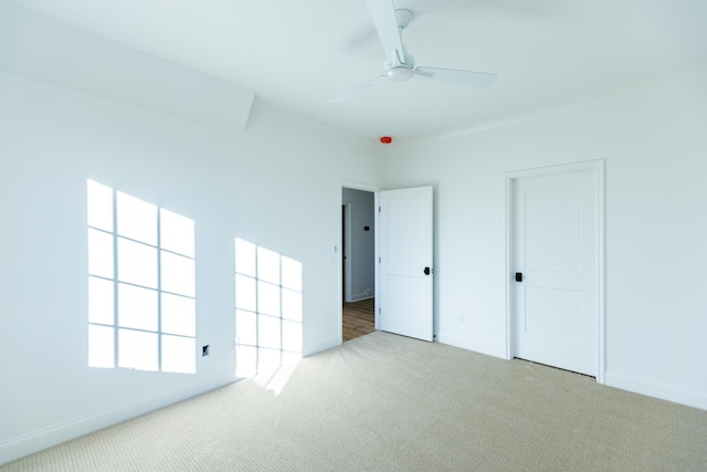 unfurnished bedroom featuring a ceiling fan, baseboards, and carpet flooring