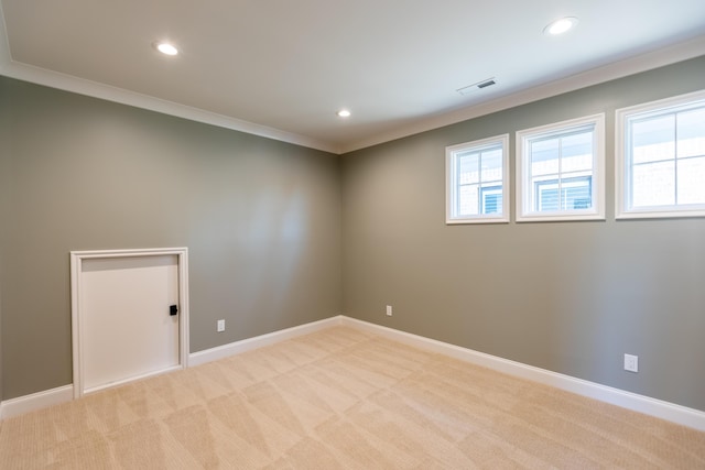 empty room with baseboards, plenty of natural light, and light colored carpet