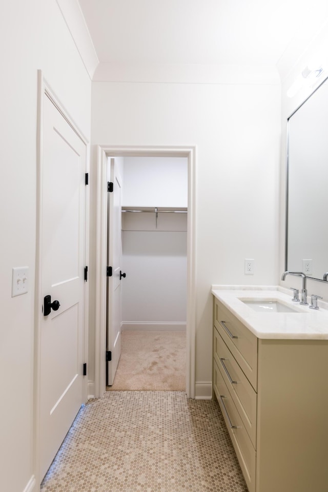 bathroom featuring ornamental molding and vanity