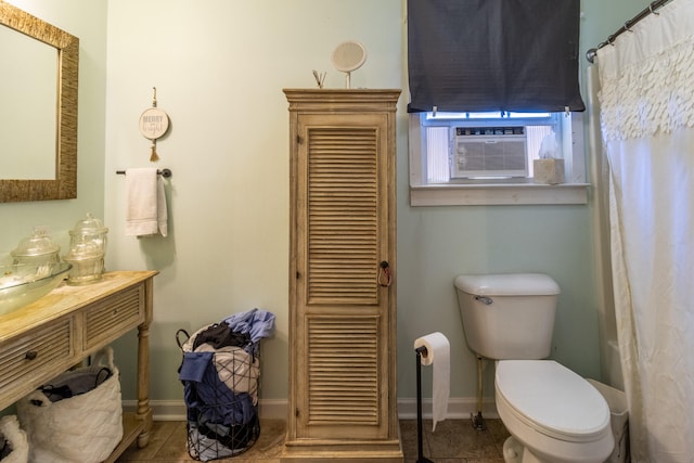 bathroom featuring tile patterned flooring, cooling unit, and toilet