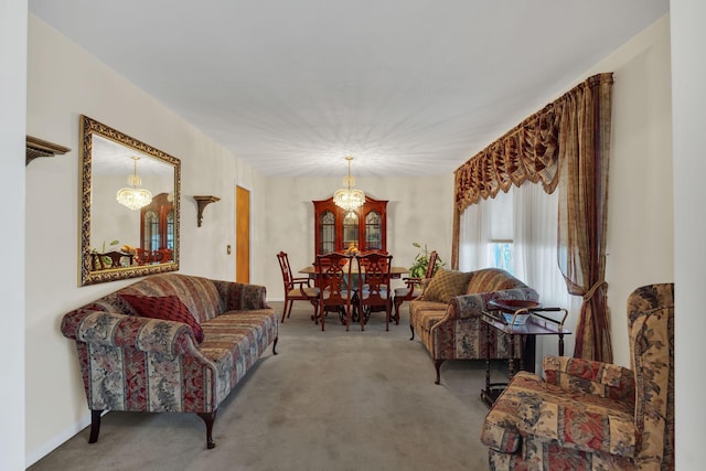 living room featuring carpet floors and an inviting chandelier