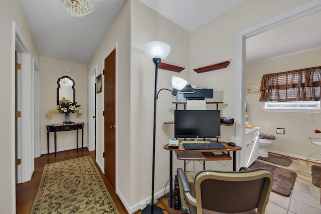 home office featuring light hardwood / wood-style flooring and a notable chandelier