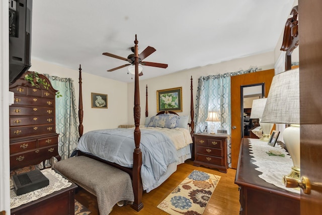 bedroom with light hardwood / wood-style floors and ceiling fan