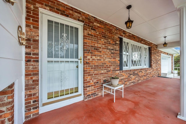 view of exterior entry with covered porch