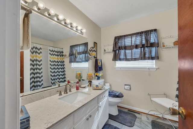 bathroom with vanity and toilet