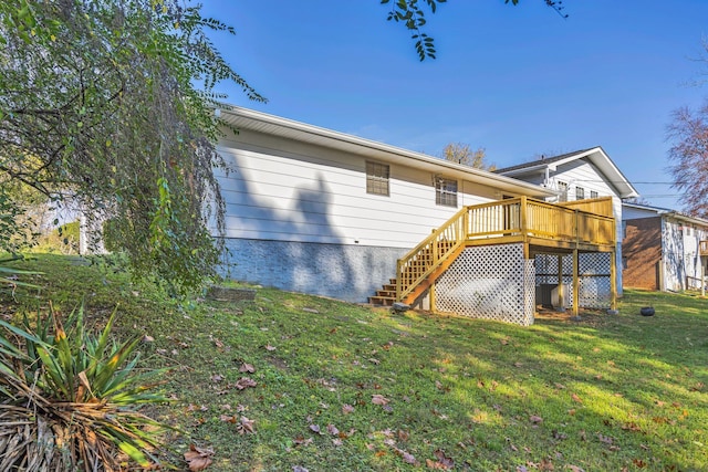 back of property featuring a lawn and a deck