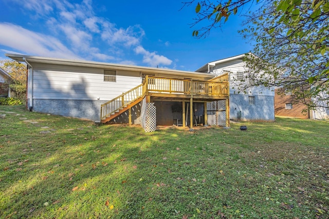 back of house featuring a lawn and a wooden deck