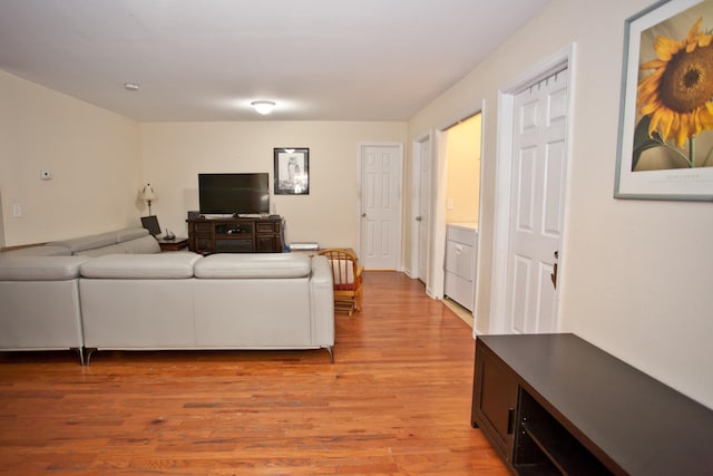 living room featuring washer / clothes dryer and light wood-type flooring