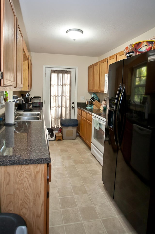 3 Fox Chase St, Rossville, GA 30741 - kitchen featuring white appliances, a sink, light tile patterned floors, and dark stone countertops