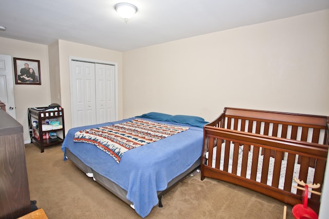 bedroom with light carpet and a closet