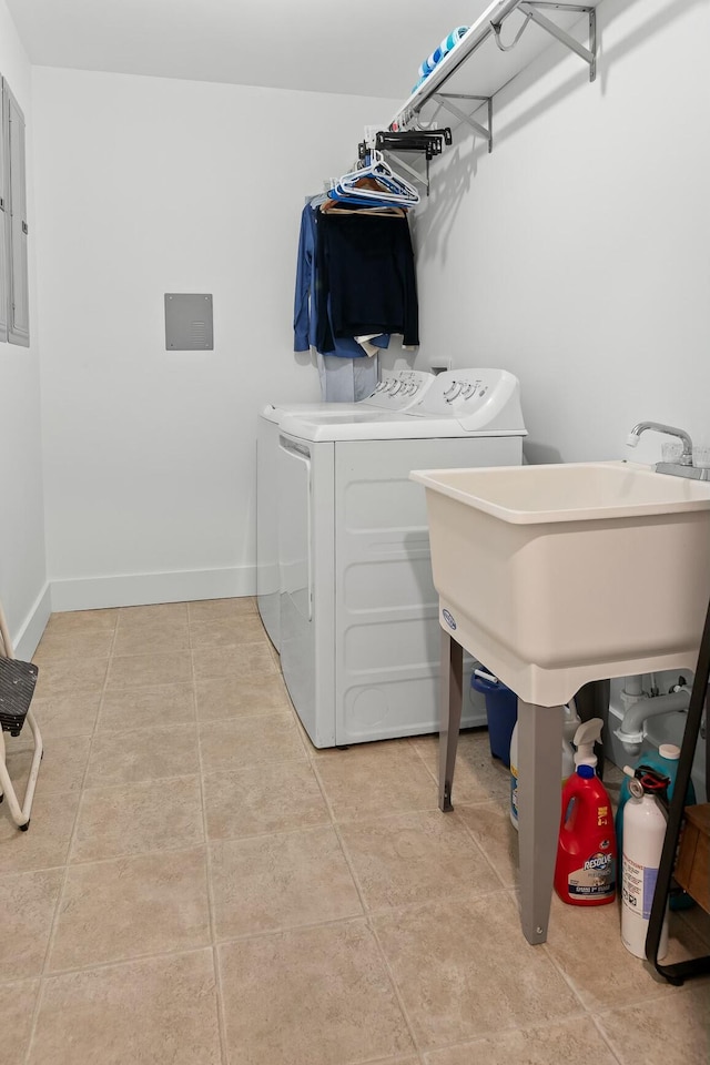 laundry area with electric panel, light tile patterned floors, and independent washer and dryer