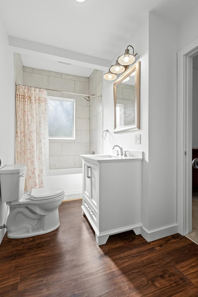 full bathroom with shower / bath combination with curtain, vanity, wood-type flooring, and toilet