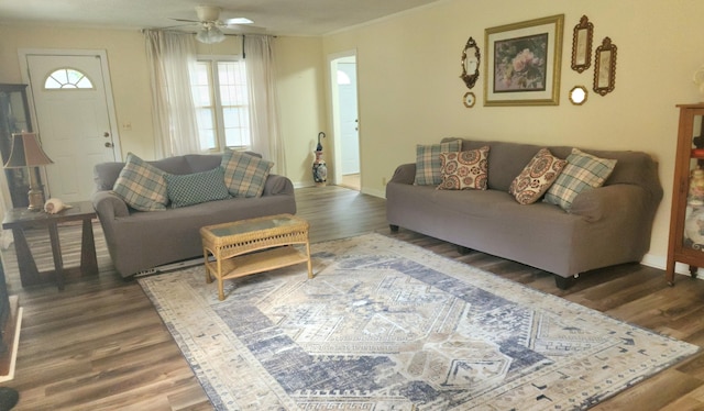 living room with ceiling fan, dark hardwood / wood-style flooring, and crown molding