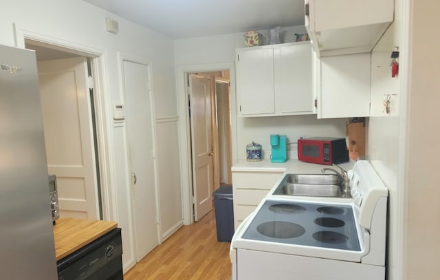 kitchen with sink, light hardwood / wood-style flooring, white cabinets, white electric range, and stainless steel refrigerator