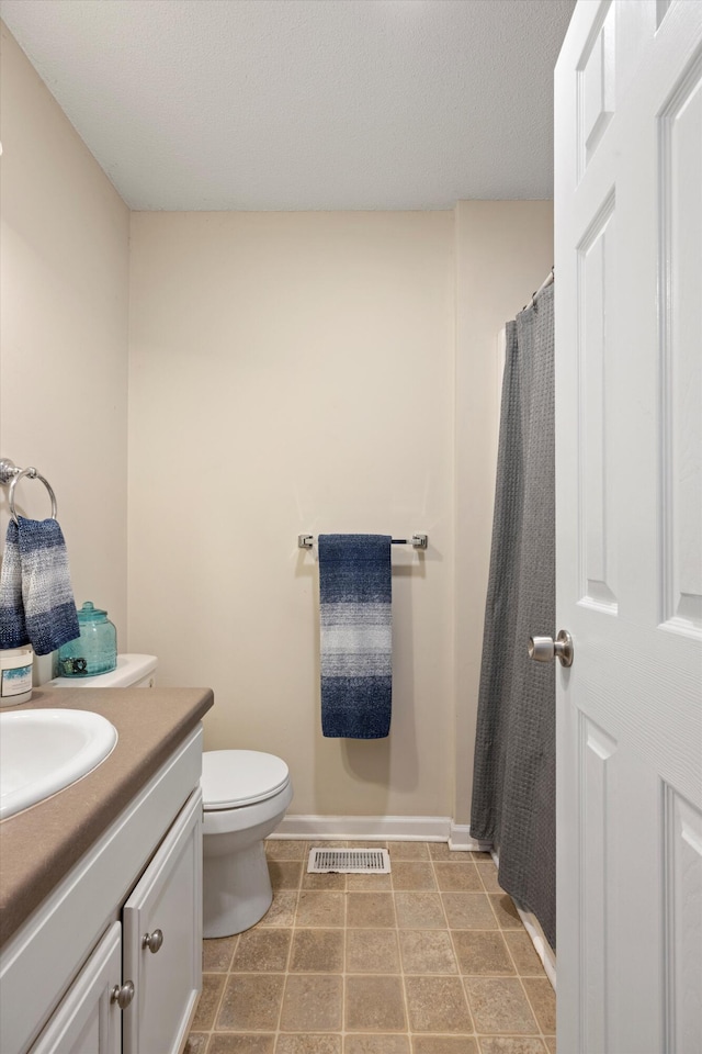 bathroom with tile patterned floors, vanity, and toilet