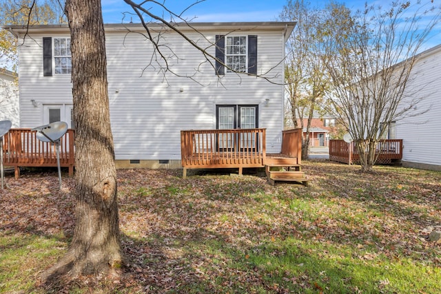 rear view of property featuring a deck