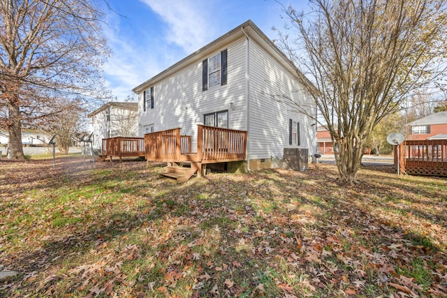 rear view of property with a lawn and a deck