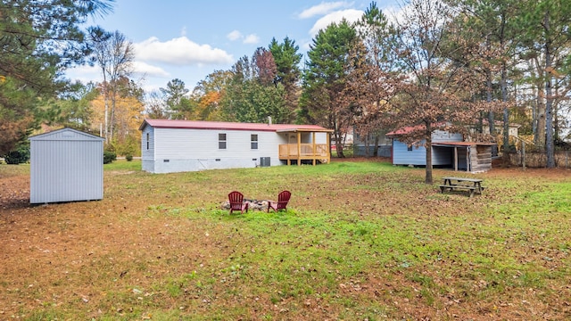 view of yard with a wooden deck and a storage shed