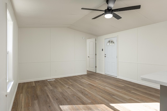 unfurnished room with hardwood / wood-style floors, ceiling fan, and vaulted ceiling