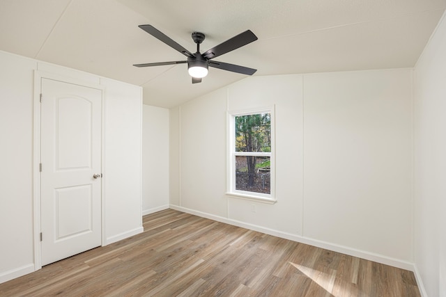 unfurnished room with light hardwood / wood-style flooring, ceiling fan, and lofted ceiling