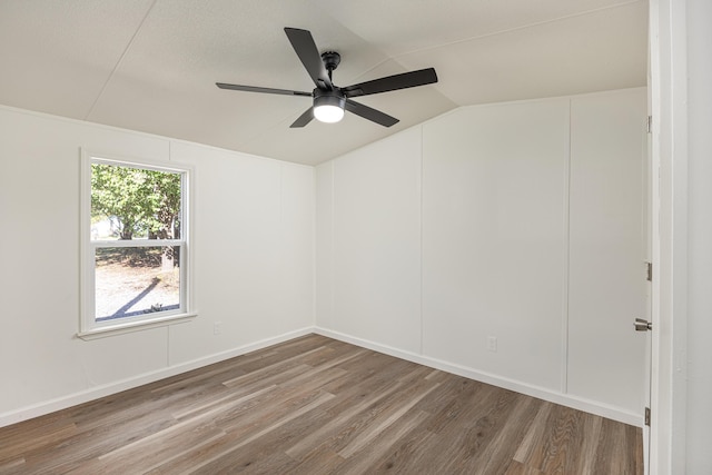 unfurnished room featuring lofted ceiling, ceiling fan, and wood-type flooring