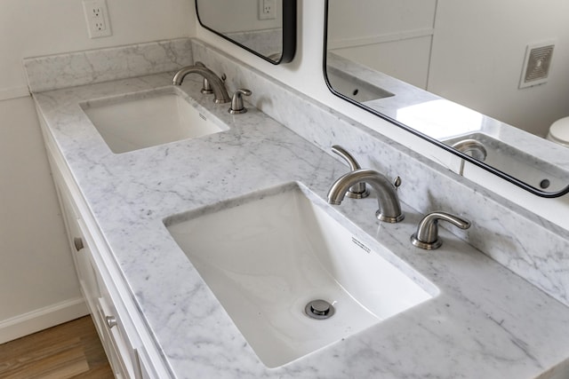 bathroom with hardwood / wood-style floors and vanity