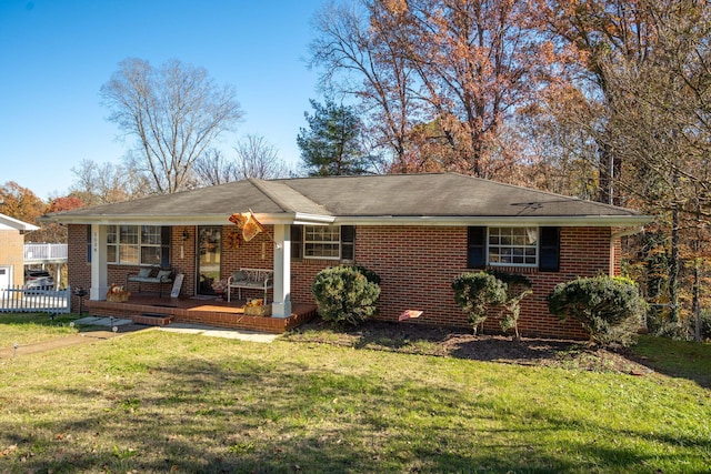 ranch-style home with covered porch and a front yard