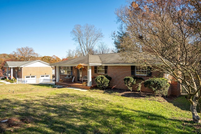 single story home featuring covered porch and a front yard