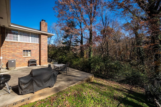 view of yard featuring a patio and central air condition unit