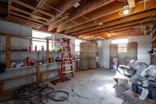 basement featuring water heater and plenty of natural light