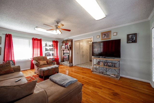 living room with ornamental molding, a textured ceiling, and hardwood / wood-style flooring