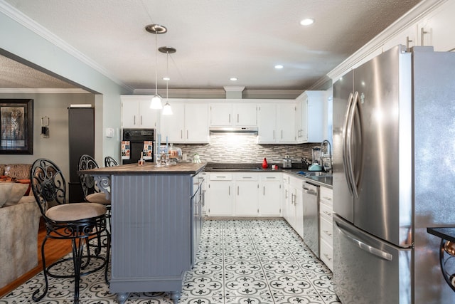 kitchen featuring white cabinets, hanging light fixtures, a breakfast bar area, and black appliances