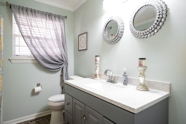 bathroom featuring toilet, vanity, wood-type flooring, and ornamental molding