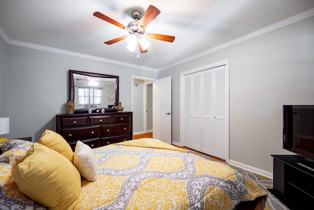 bedroom with ceiling fan, a closet, crown molding, and a textured ceiling