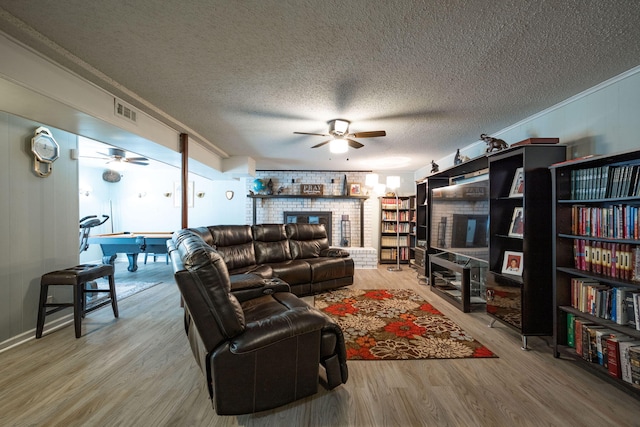 living room with wood-type flooring and a textured ceiling