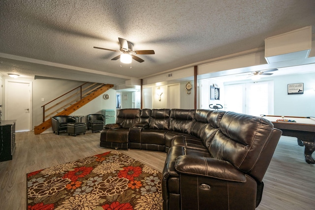 living room with hardwood / wood-style floors, a textured ceiling, ceiling fan, and pool table