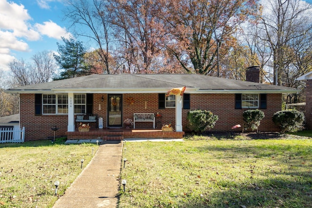 ranch-style house with a front yard and covered porch