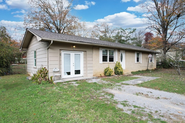 view of front of home with french doors and a front lawn