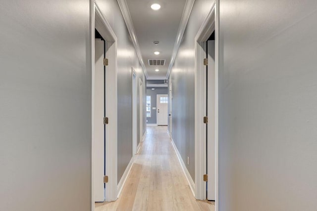 hallway featuring crown molding and light wood-type flooring