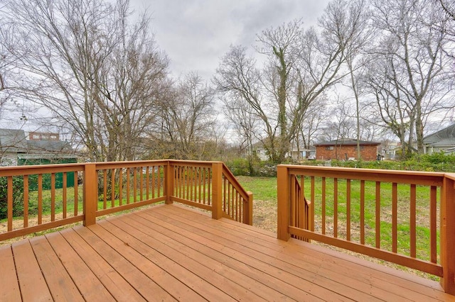 wooden deck featuring a yard