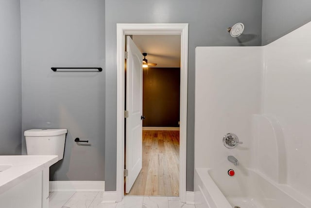 full bathroom featuring shower / bathing tub combination, hardwood / wood-style floors, vanity, ceiling fan, and toilet