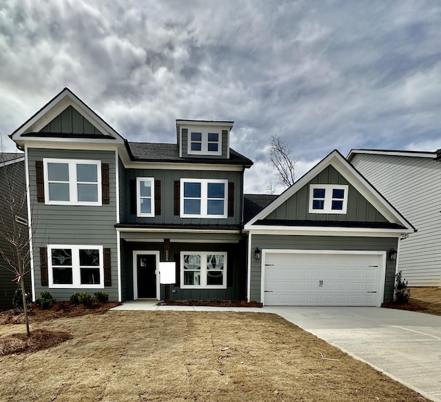 craftsman inspired home with a garage, board and batten siding, and concrete driveway