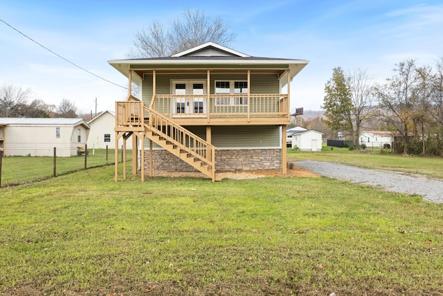 rear view of property featuring a yard