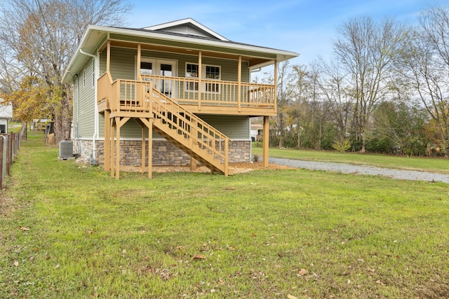 back of house with a deck, a yard, and central air condition unit