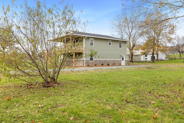 back of property featuring a lawn