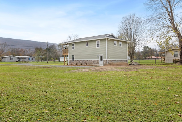 back of house with a lawn