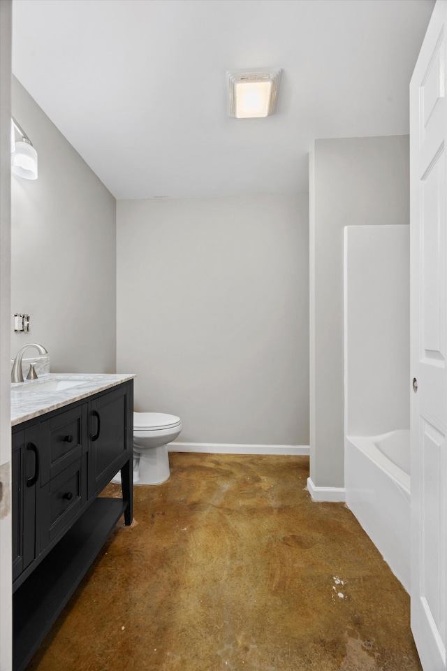 bathroom featuring a tub to relax in, vanity, and toilet